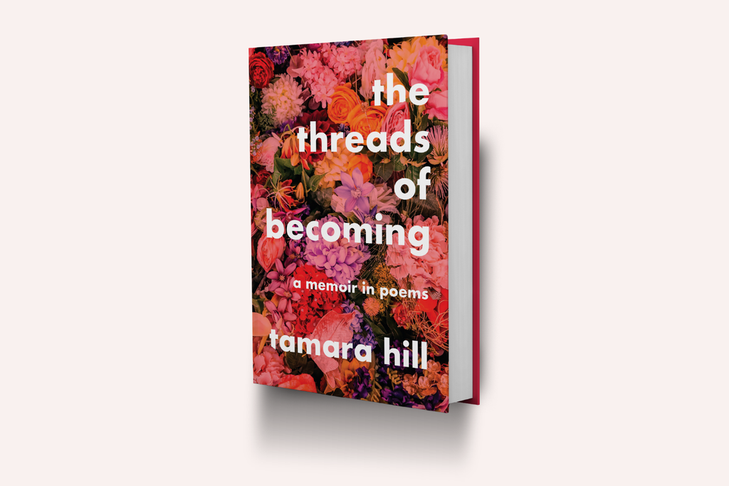 Book titled 'The Threads of Becoming' by Tamara Hill with a pink floral design on the cover. 